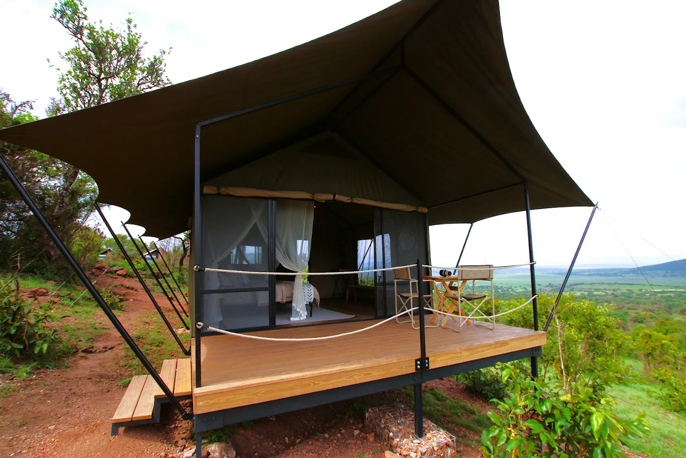 A canvas safari tent on a raised timber deck looking over open bush at Karenge Bush Camp in Akagera National Park, Rwanda